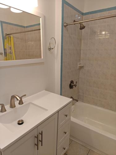a bathroom with a sink and a tub and a shower at JSQ Apartment, 5 Mins from PATH Station in Jersey City