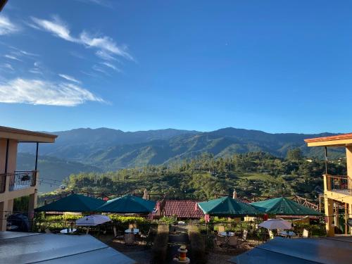 a view of a resort with mountains in the background at Hotel Orocay Lodge in Cartago