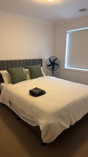 a large bed in a bedroom with a window at The Blissful Abode in Truganina