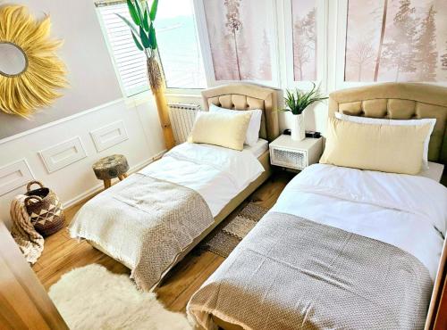 a bedroom with two beds and a window at Premium Beachfront Residences in Durrës
