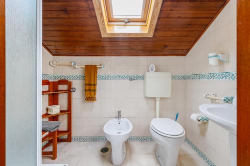 a bathroom with a toilet and a sink at Casa de Colares - Sintra Beach Pool Surf Getaway Work and Play in Colares