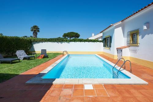 a swimming pool in the backyard of a house at Casa de Colares - Sintra Beach Pool Surf Getaway Work and Play in Colares