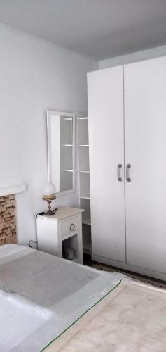 a bedroom with a bed and a dresser and a mirror at Apto com charme conforto vista e completo in Florianópolis