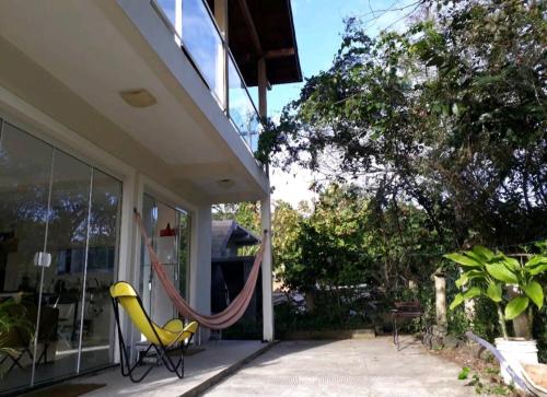 a hammock on the porch of a house at Casa da Amandinha in Florianópolis