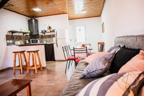 a living room with a couch and a kitchen at The Sweet Apart Hotel in San Javier