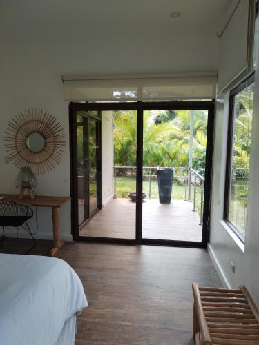 a bedroom with a door leading to a deck at Hotel Luna Bella in Talamanca