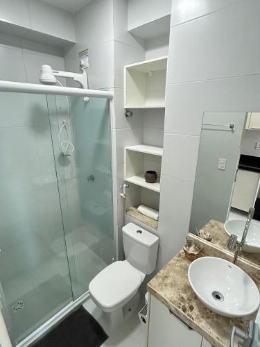 a bathroom with a shower and a toilet and a sink at Melhores Flats - Formosura 5min da praia de Tambaú in João Pessoa
