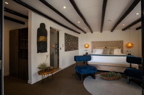 a bedroom with a bed and a blue chair at GreenOriental Resort in La Vega