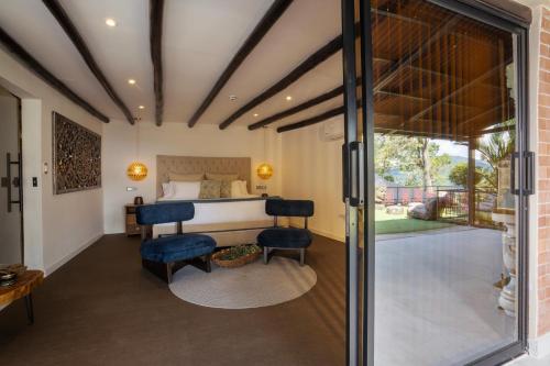 a bedroom with a bed and a sliding glass door at GreenOriental Resort in La Vega