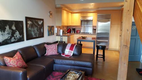 a living room with a couch and a kitchen at Orenco Lofts in Hillsboro