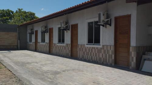 a row of doors and windows on a building at Residência Lençóis Pousada in Barreirinhas