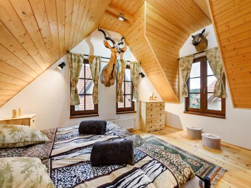 a bedroom with a bed with a deer head on the wall at Villa in Varva ov near Ski Slopes in Varvažov