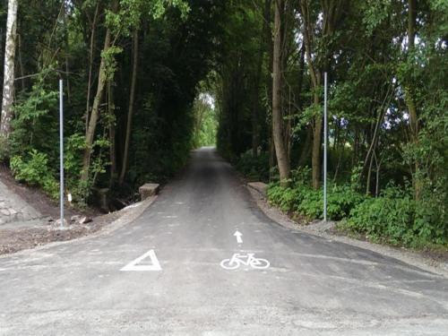 a bike lane on a road with trees at Holiday Home in Kladno with Private Pool in Lány