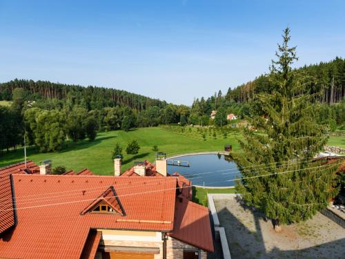 an aerial view of a house with a lake at Villa in Varva ov with Garden and Barbecue in Varvažov