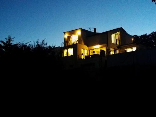 a large house with its lights on at night at Holiday Home in Kladno with Private Pool in Lány