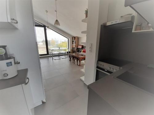 a kitchen with a stove and a living room at Holiday Home in Kladno with Private Pool in Lány