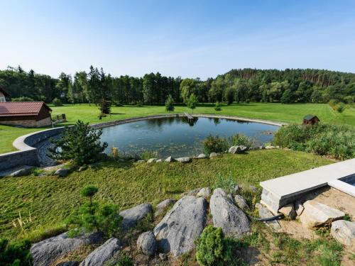 a pond in the middle of a field at Villa in Varva ov with Garden and Barbecue in Varvažov