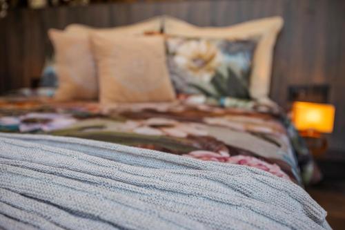 a bed with pillows and a lamp in a bedroom at GreenOriental Resort in La Vega