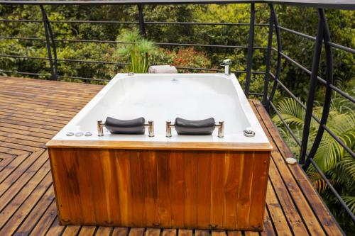 a bath tub sitting on top of a wooden deck at GreenOriental Resort in La Vega