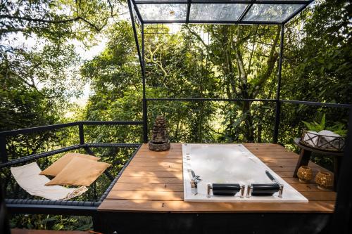 a bathroom sink on a wooden table on a deck at GreenOriental Resort in La Vega