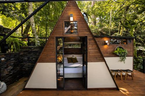a room with a bed in a tree house at GreenOriental Resort in La Vega