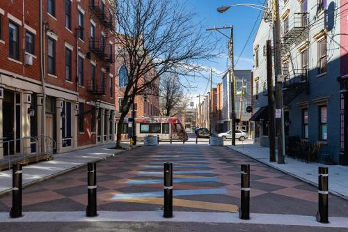 an empty street in a city with a bus at Modern Condo in the heart of Over-The-Rhine in Cincinnati
