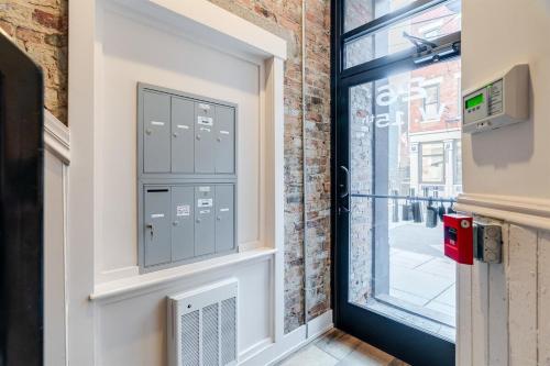 a door with a window and a brick wall at Modern Condo in the heart of Over-The-Rhine in Cincinnati