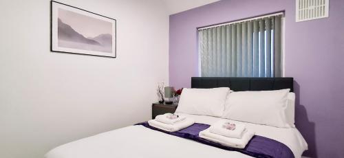 a bedroom with a bed with two towels on it at Charming 3-Bedroom Home Near NEC, Birmingham Airport & Bullring in Birmingham