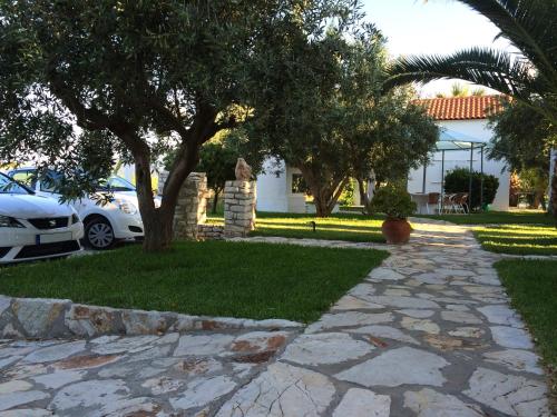 a stone walkway in front of a house at Houdis Houses in Paralion astros