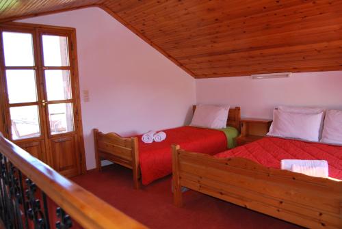 um quarto com 2 camas num quarto com uma varanda em Houdis Houses em Paralio Astros