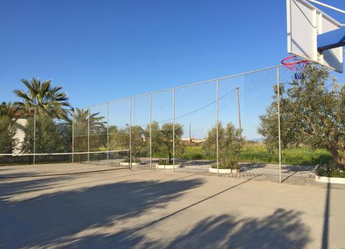 a basketball court with a net at Houdis Houses in Paralion astros