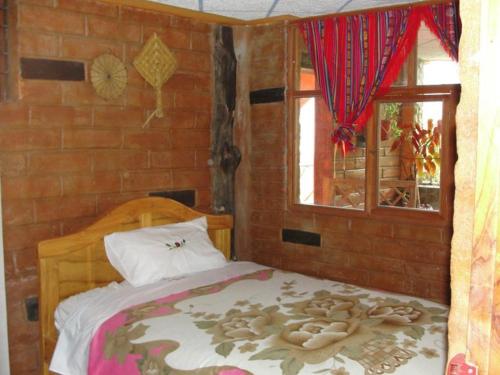 Postel nebo postele na pokoji v ubytování Hostal Rumyhuasy