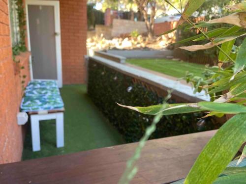 a bench sitting on the side of a building at 2 bedroom Beach cafes shops bus all a walk away in Deewhy