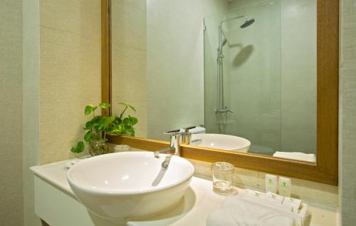 a bathroom with a sink and a mirror at Hanging Garden Hoi An in Hoi An