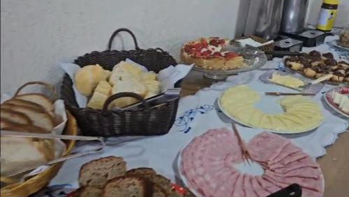 a table topped with lots of different types of food at Pousada D' Paula in Campos do Jordão