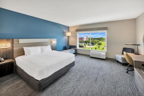 a hotel room with a bed and a window at Holiday Inn Express & Suites Fort Walton Beach - Eglin Area by IHG in Fort Walton Beach