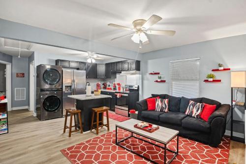 a living room with a couch and a kitchen at Central RVA Home 4 Bed, 3 Bath Getaway! in Richmond