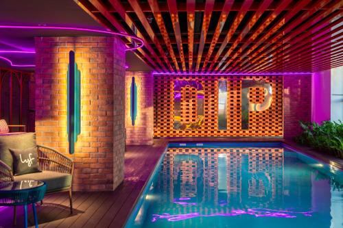 a swimming pool with a neon sign that reads end at lyf Georgetown Penang in George Town