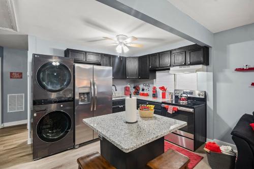 a kitchen with stainless steel appliances and a counter at Central RVA Home 4 Bed, 3 Bath Getaway! in Richmond