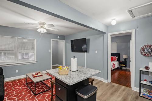 a living room with a table and a ceiling fan at Central RVA Home 4 Bed, 3 Bath Getaway! in Richmond