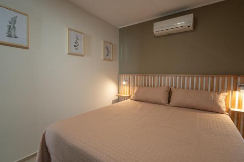 a bedroom with a bed with two lights on it at Complejo Solares in Alta Gracia