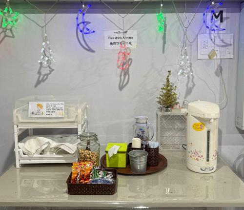 a kitchen counter with christmas decorations on a wall at Sleep At Home - Don Mueang in Bangkok