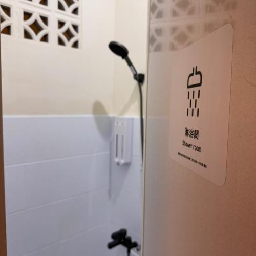 a microphone on a wall next to a sink at 可以住Canlive中西區海安路包棟民宿-一日只接待一組 in Tainan