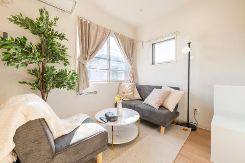 a living room with a couch and a table at Urban Villa Sumida in Tokyo