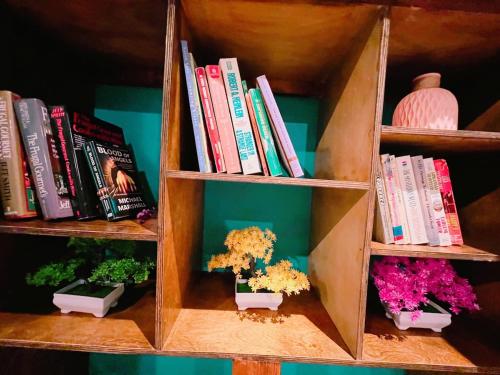 a book shelf with books and some plants and flowers at Pet friendly 2 bedroom located in the heart of OKC in Oklahoma City