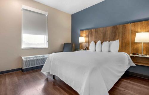 a large white bed in a room with a window at Extended Stay America Premier Suites - Charlottesville in Charlottesville