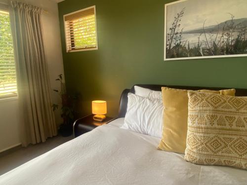 a bedroom with a white bed and a window at Fairhall Guest Lodge in Woodbourne