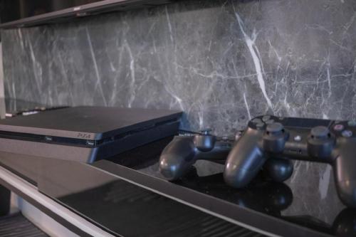 a couple of video game controllers sitting on a table at Meritus Suites - 8pax in Perai