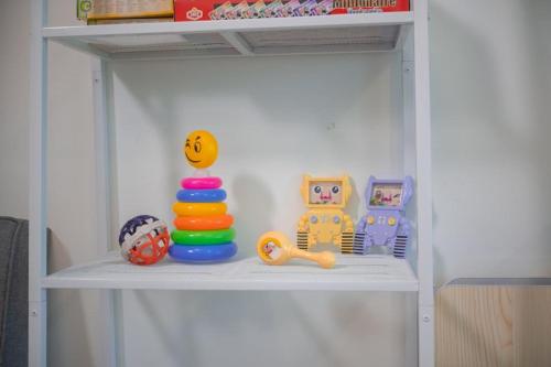 a white shelf with toys on top of it at Meritus Suites - 8pax in Perai