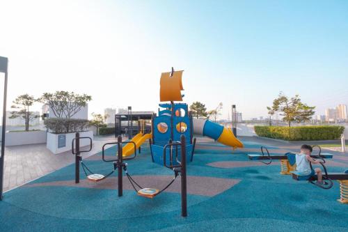 a child is playing on an outdoor playground at Meritus Suites - 8pax in Perai